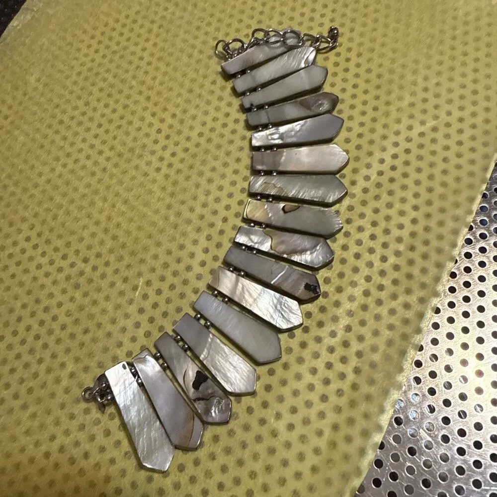 Bracelet made of grey, possibly mother-of-pearl or shell, dagger or leaf-shaped